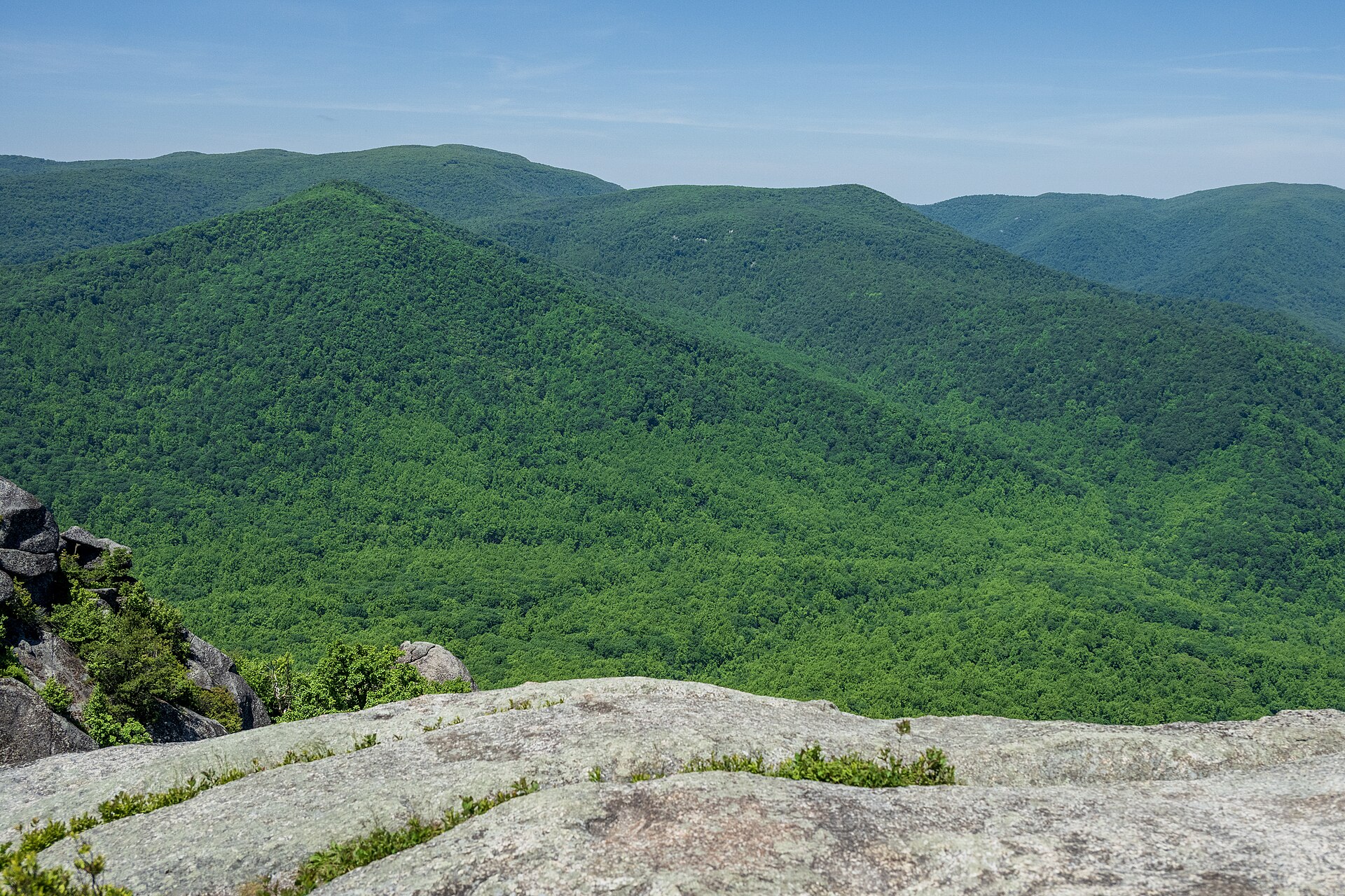 The view from Old Rag's granite summit across densely forested Blue Ridge ridgelines fading into haze