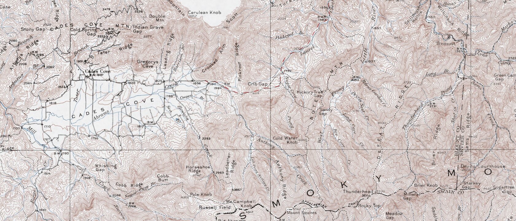 Detail from a USGS topographic map of Great Smoky Mountains National Park showing Cades Cove as an almost blank flat valley floor, ringed by densely packed contour lines on the surrounding ridges