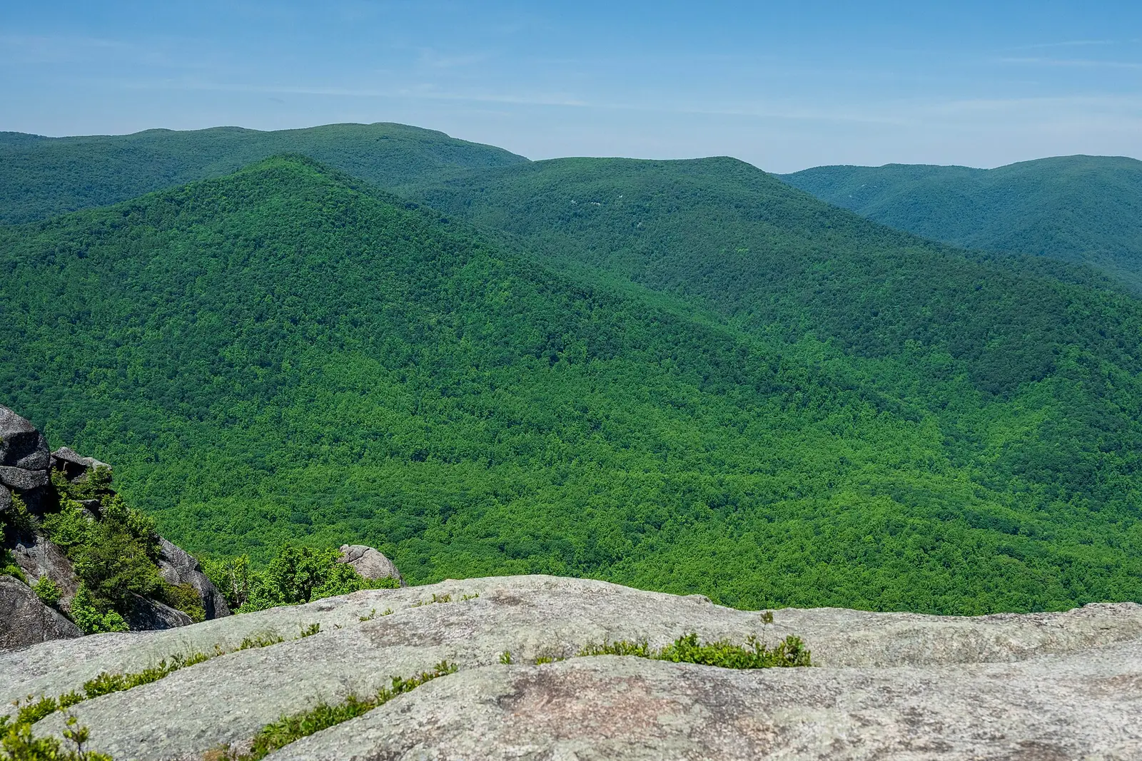 The view from Old Rag's granite summit across densely forested Blue Ridge ridgelines fading into haze